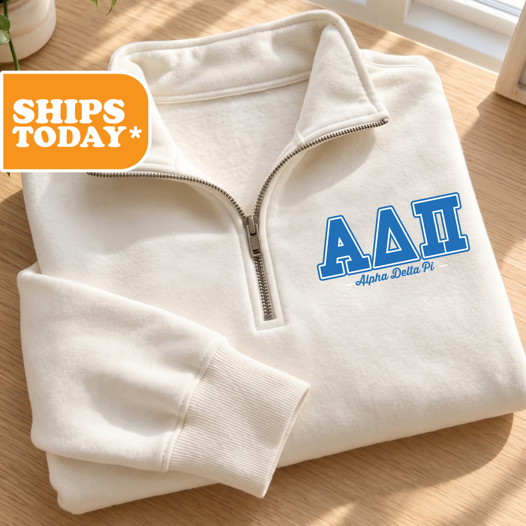 A white zip-up jacket with the letters 'ΑΓΑΙ' printed on it, placed on a wooden surface.