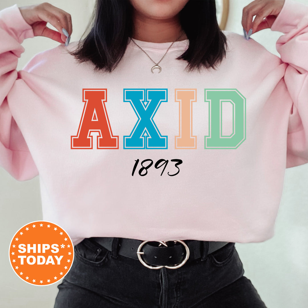 a woman wearing a pink sweatshirt with the word axid printed on it