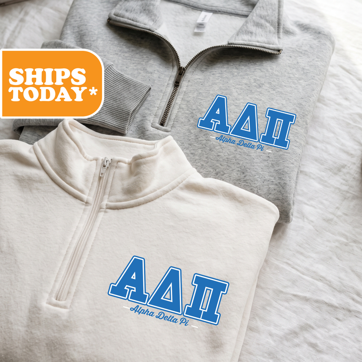 Two gray and white sweatshirts with the letters 'AA' printed on them, along with the text 'Alpha Delta Pi' below the letters.