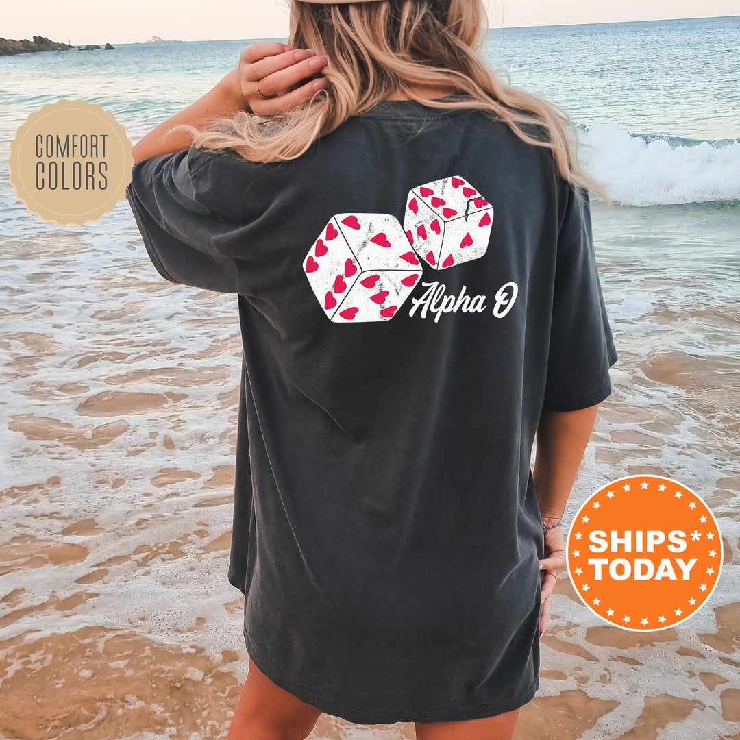 a woman standing on a beach wearing a black shirt