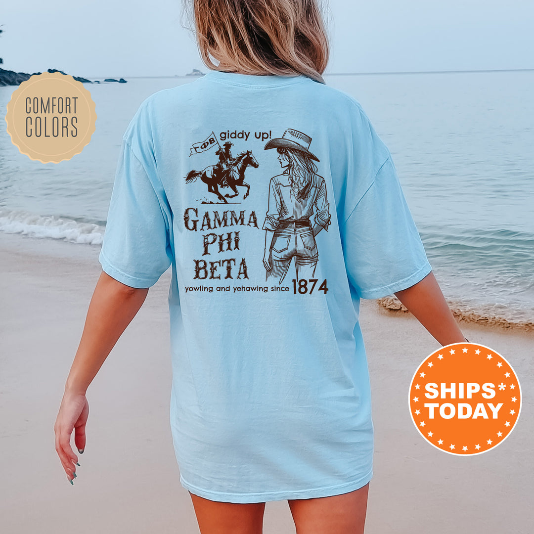 a woman walking on the beach wearing a blue shirt