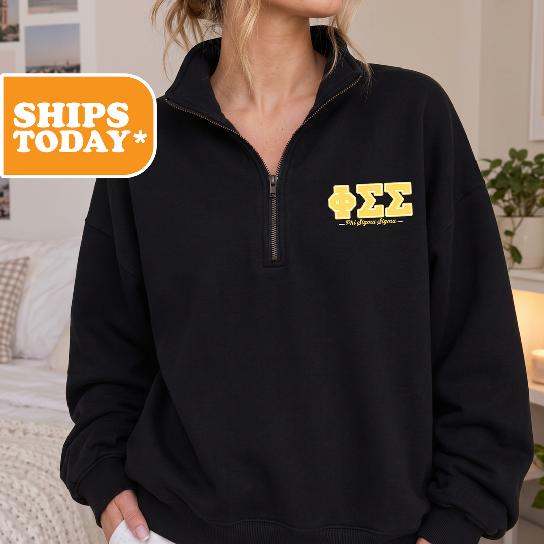 A person wearing a black sweatshirt with a yellow Sigma Theta logo on the left side.