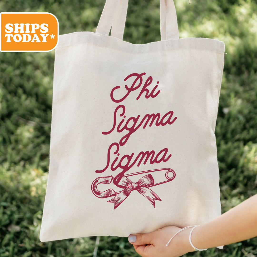 a person holding a tote bag that says phi sigmma sigmma