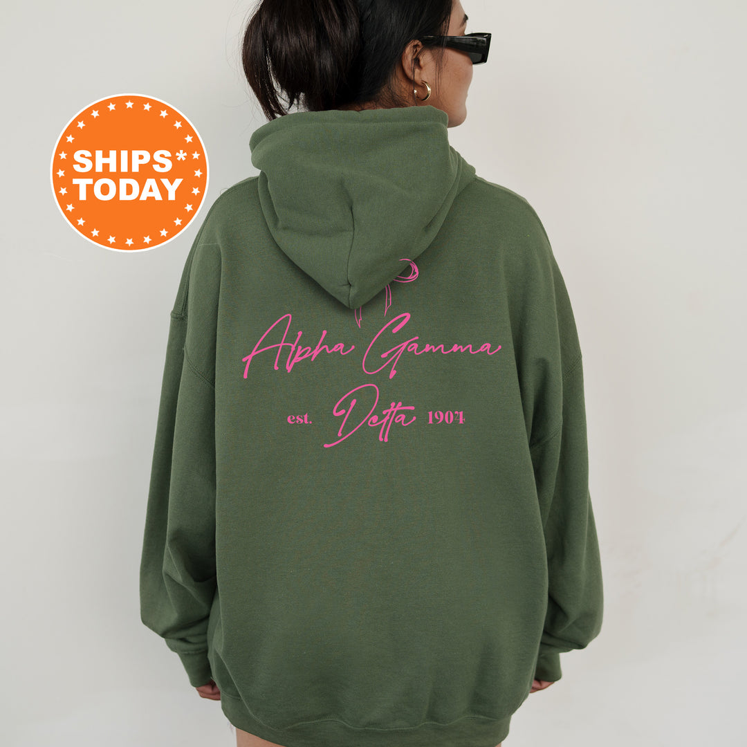 a woman wearing a green hoodie with pink writing on it