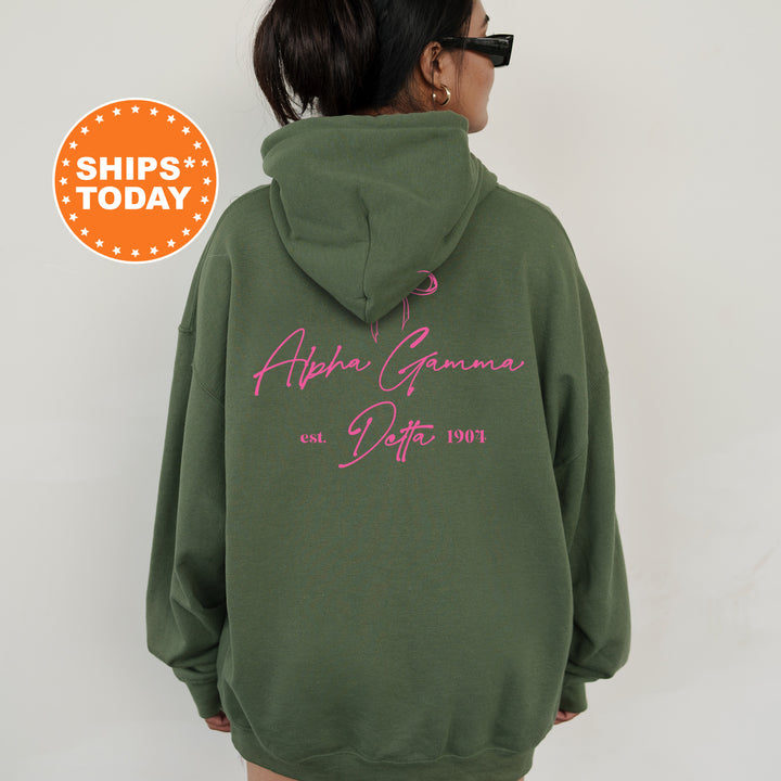 a woman wearing a green hoodie with pink writing on it