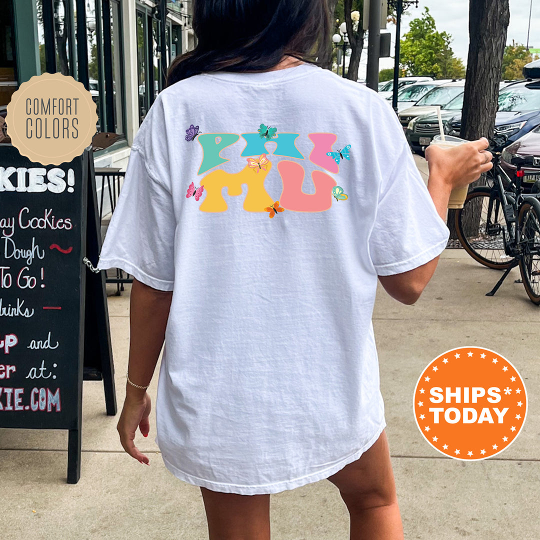 a woman walking down a sidewalk holding a donut