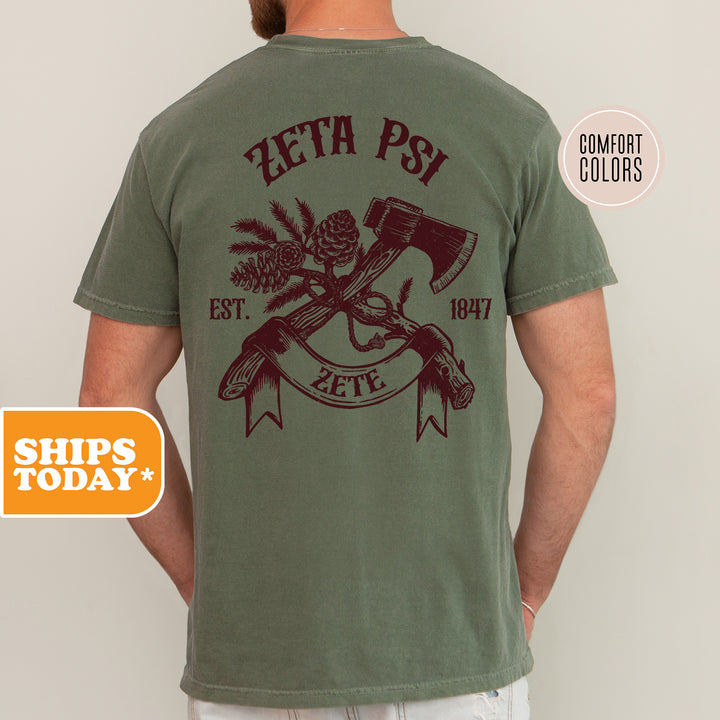 a man wearing a green shirt with a hammer and pine cones on it