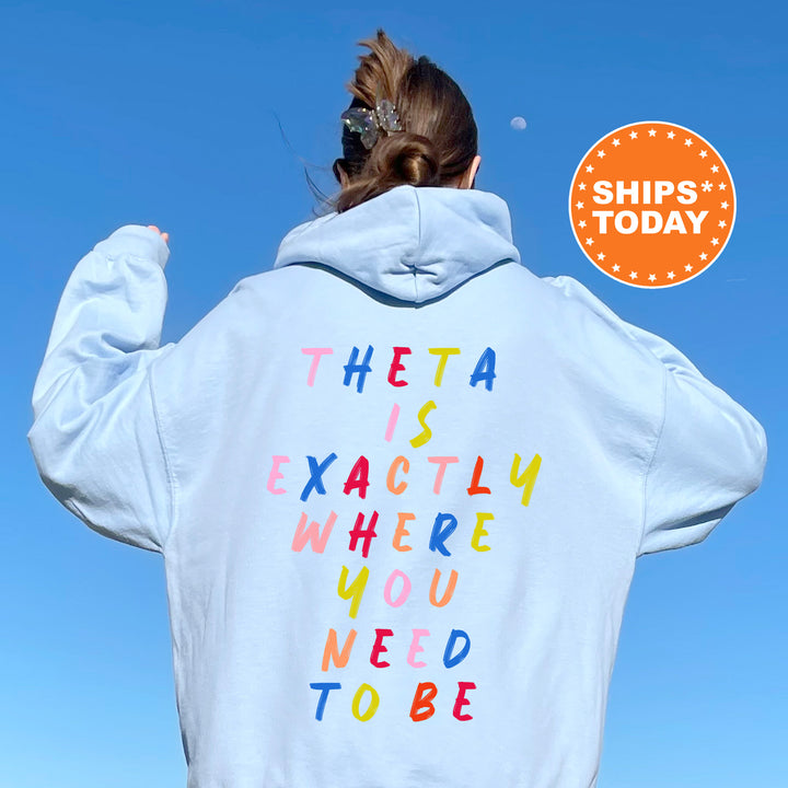 a woman with her back to the camera wearing a white hoodie with the words