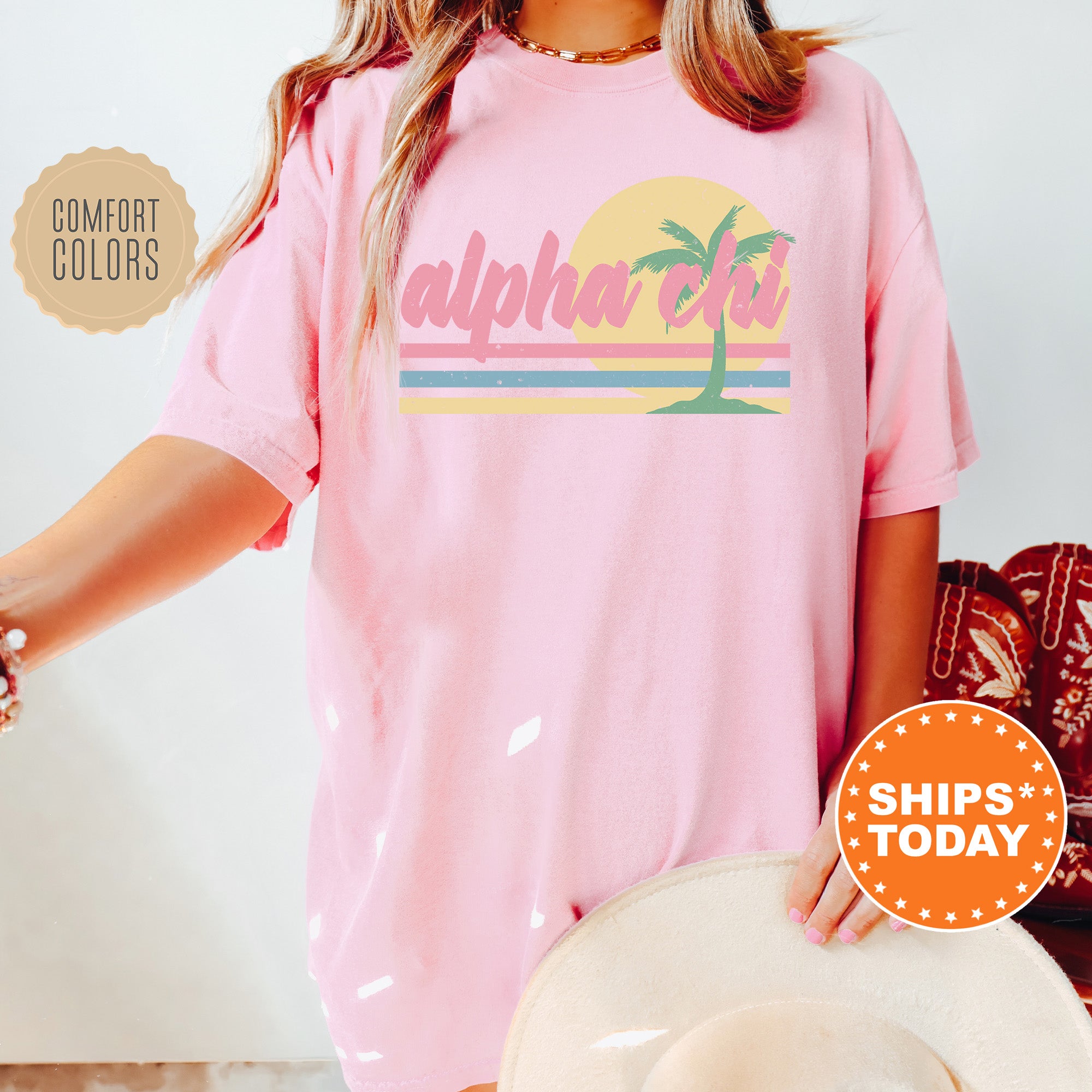 a woman wearing a pink shirt with a palm tree on it