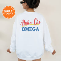 A person wearing a white sweatshirt with the text 