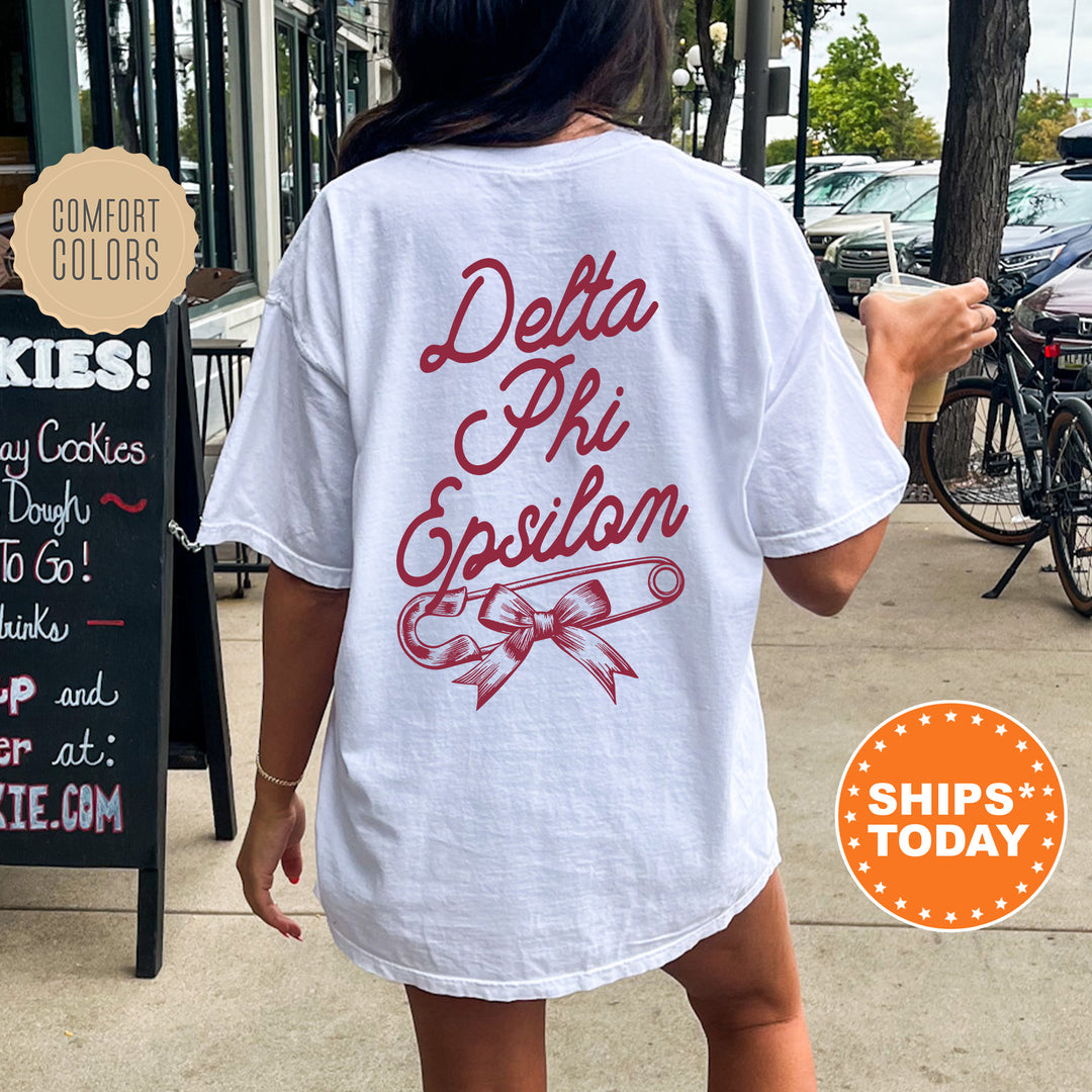 a woman walking down a sidewalk holding a donut