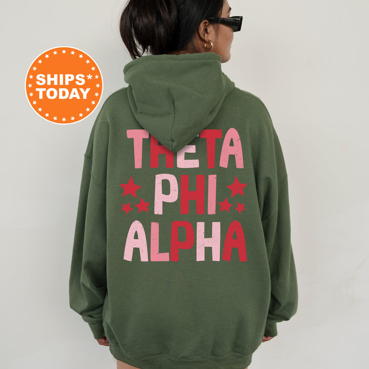 a woman wearing a green hoodie with the words tea phi alpha on it