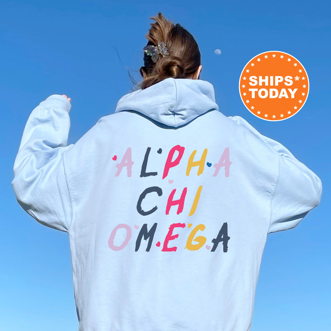 a woman wearing a white hoodie with the words alpha chi omeg