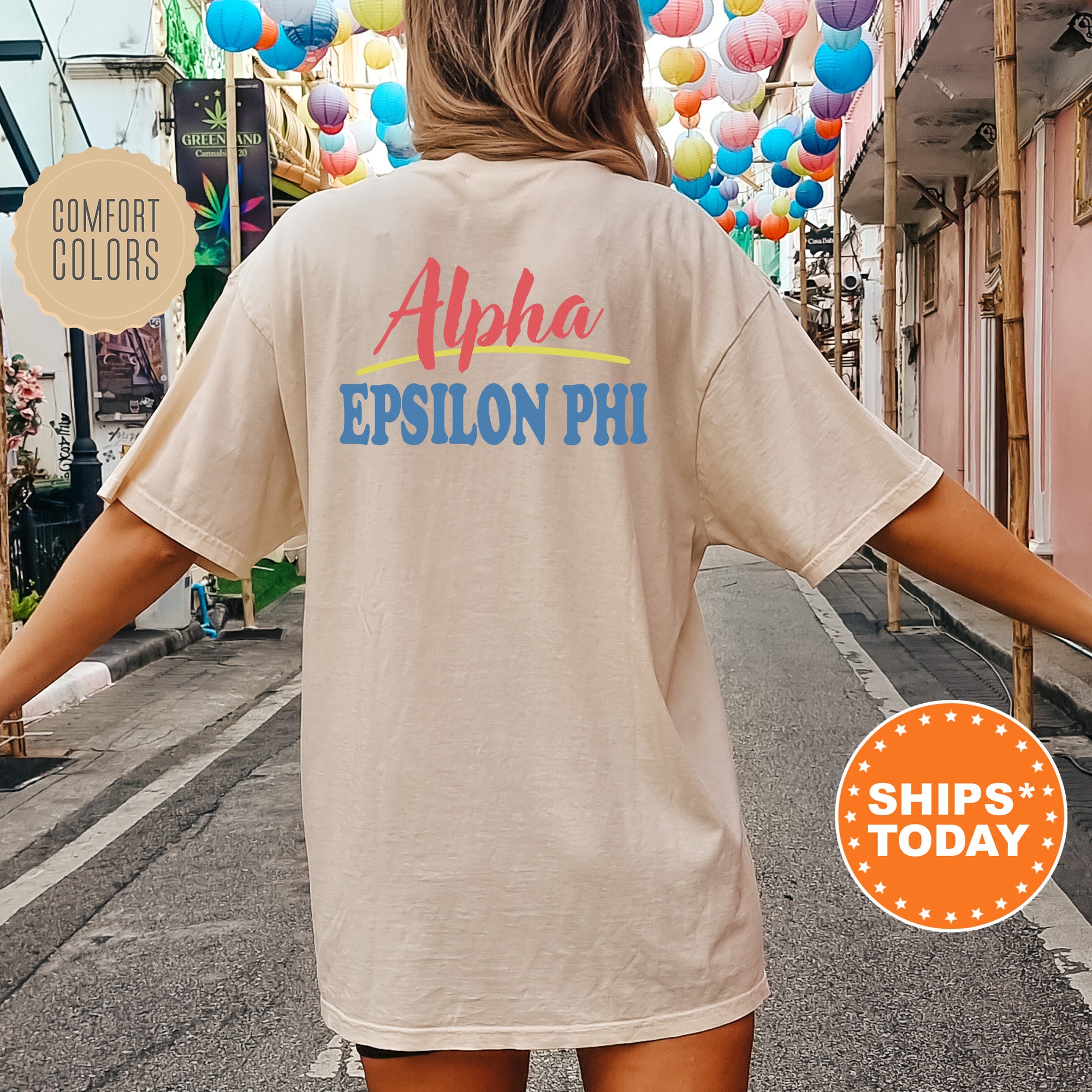 A person wearing a cream-colored t-shirt with the text 