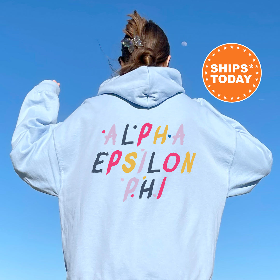 a woman wearing a white hoodie with the words alpha epsilon