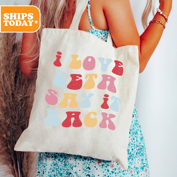 a woman holding a tote bag that says love you rock