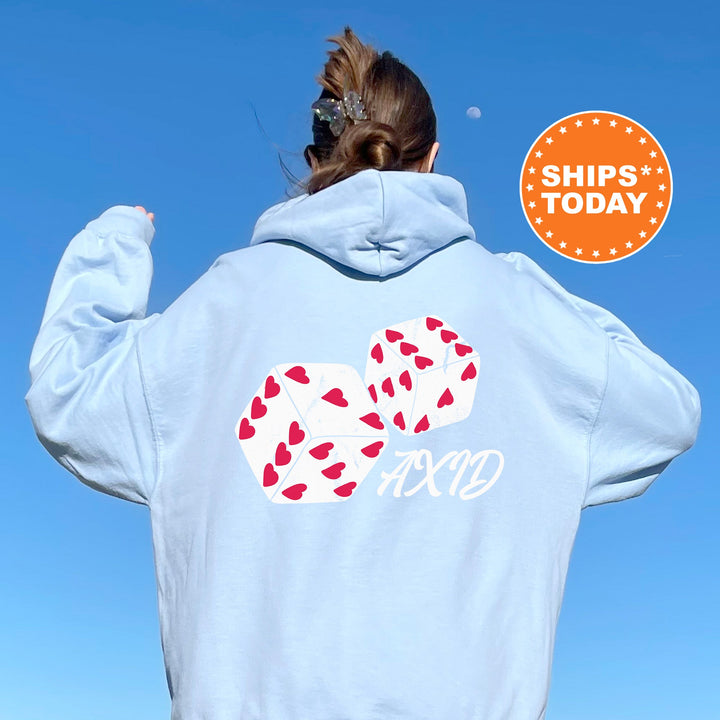 a woman wearing a blue hoodie with a red and white design on it