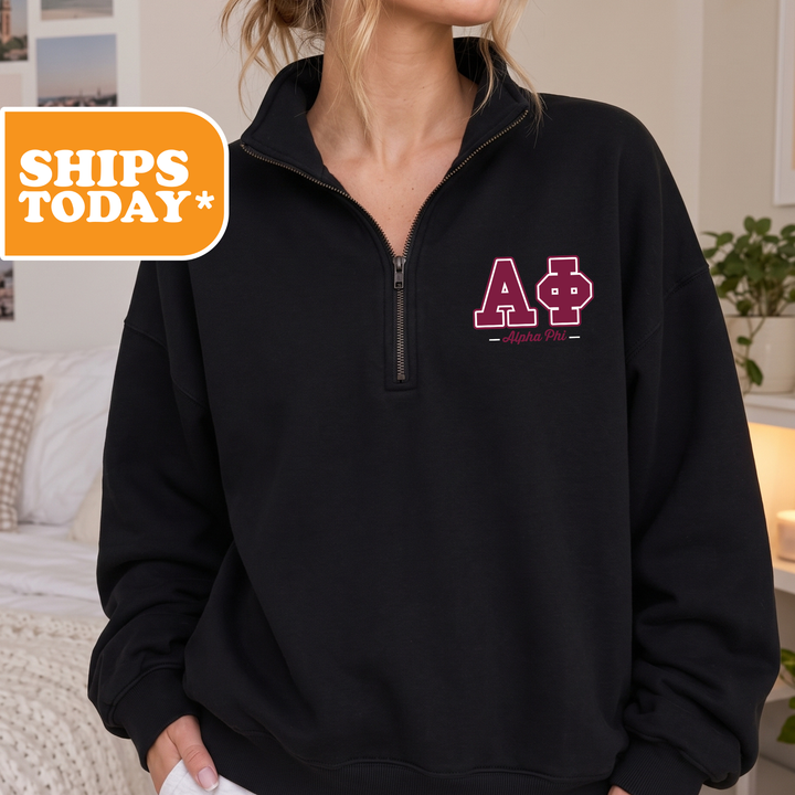 A woman wearing a black sweatshirt with a pink Greek lettering on the front.