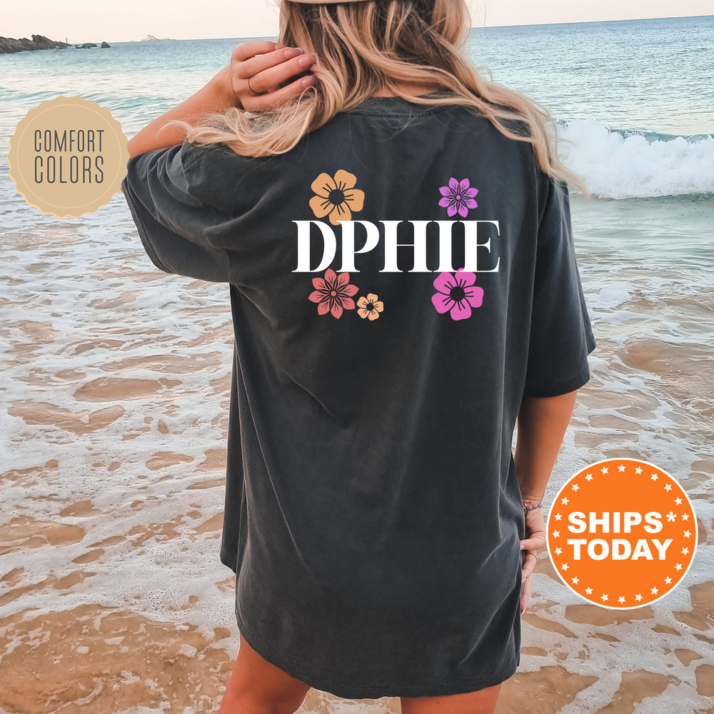 a woman standing on the beach wearing a phi phi shirt
