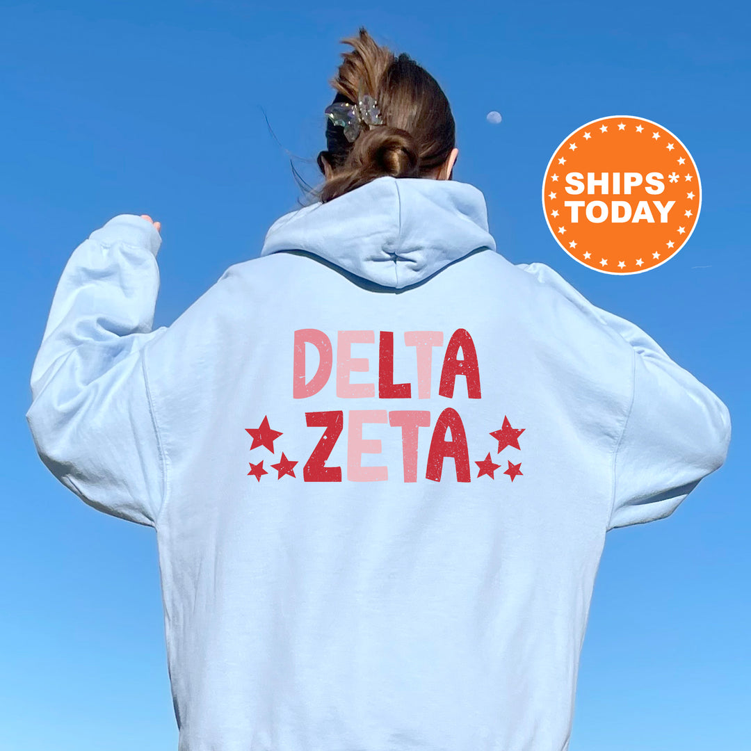 a woman with her back to the camera wearing a white delta sweatshirt