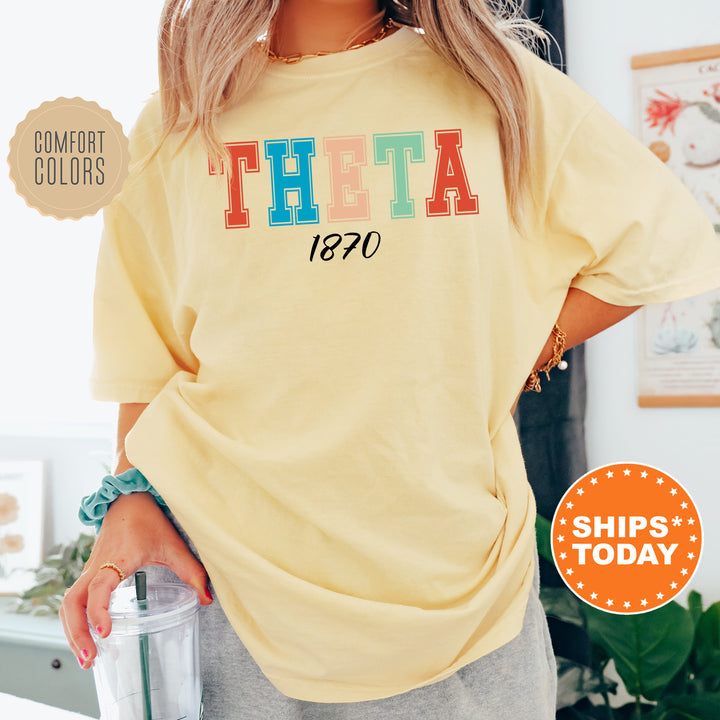 a woman wearing a yellow t - shirt with the word thea printed on it