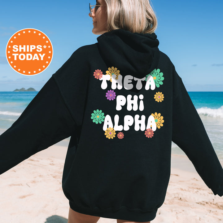 a woman wearing a black hoodie with the words delta phi aloh on it