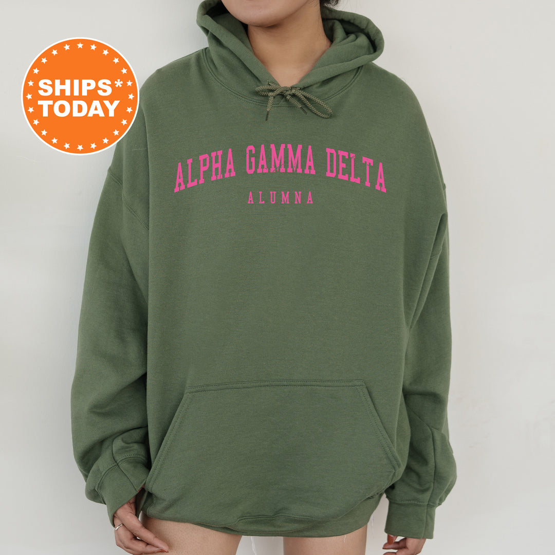 a woman wearing a green hoodie with pink letters on it