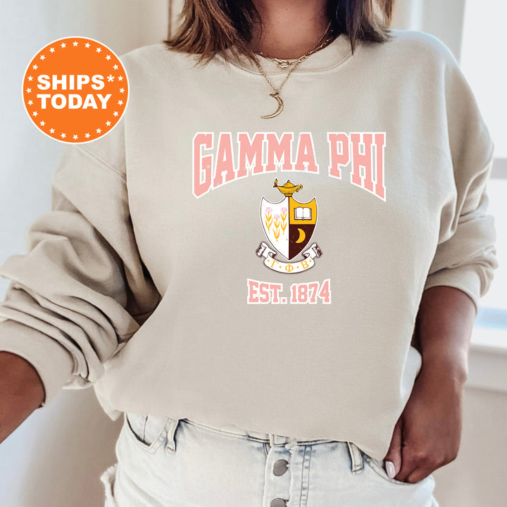 a woman wearing a sweatshirt with the words gama phi on it