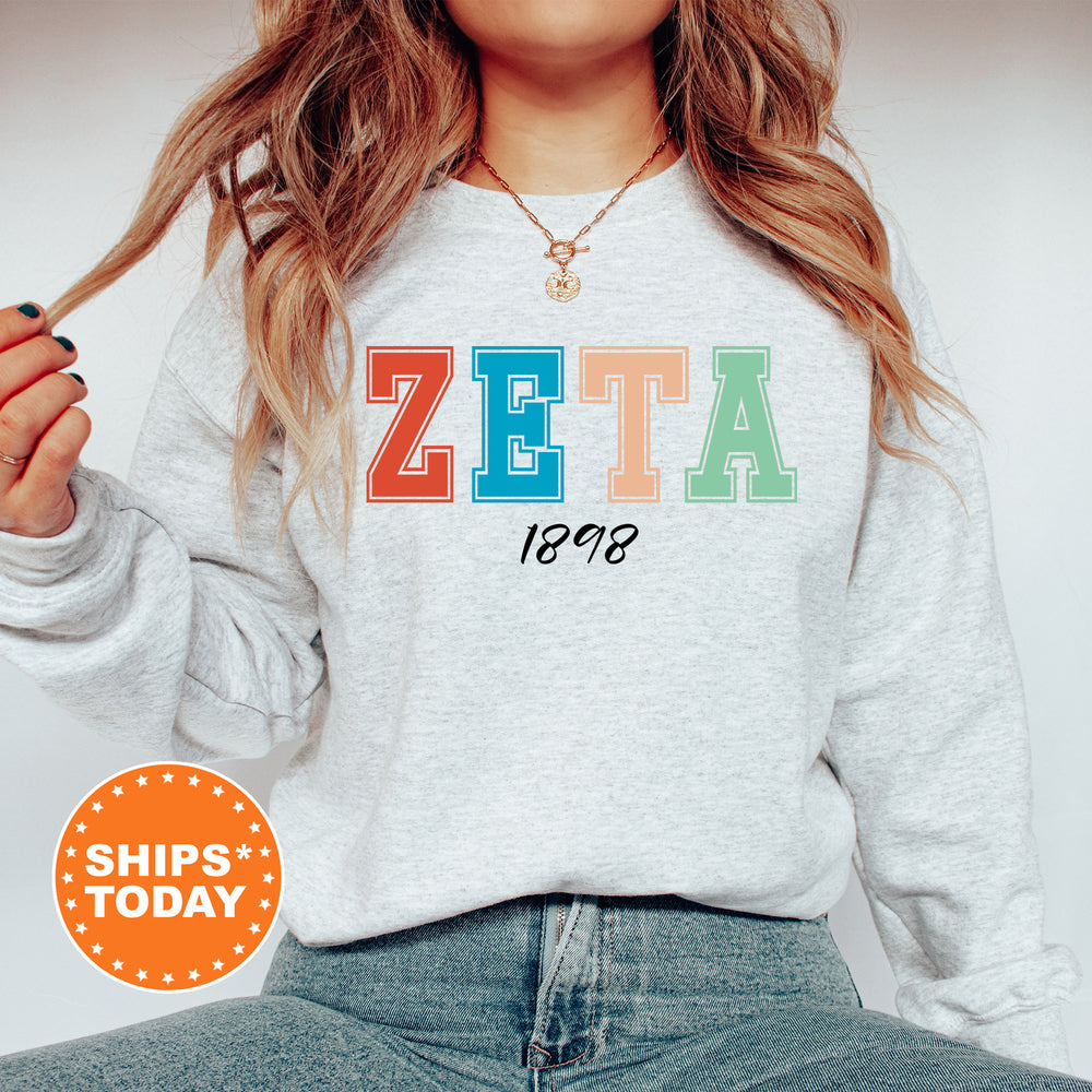a woman wearing a sweatshirt with the word zeta printed on it