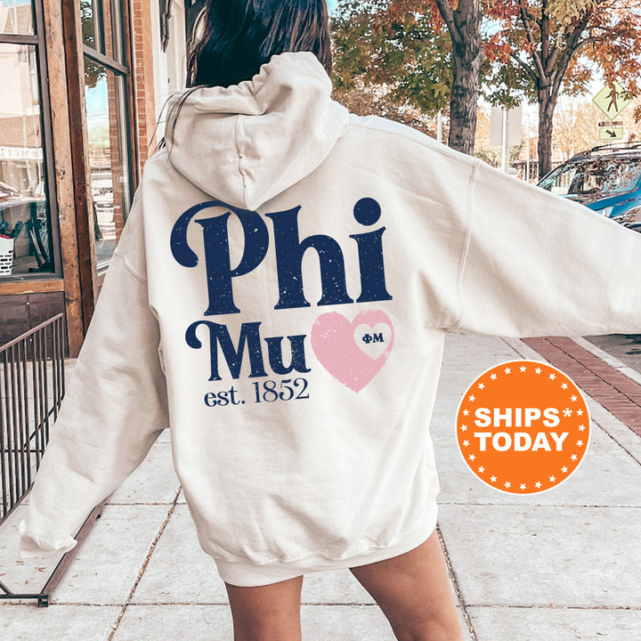 a woman in a white hoodie is walking down the street
