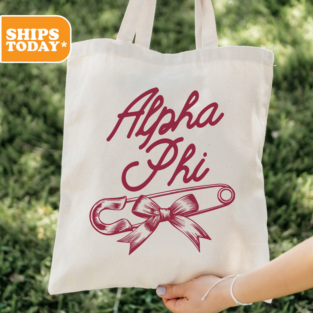 a person holding a tote bag with a ribbon on it
