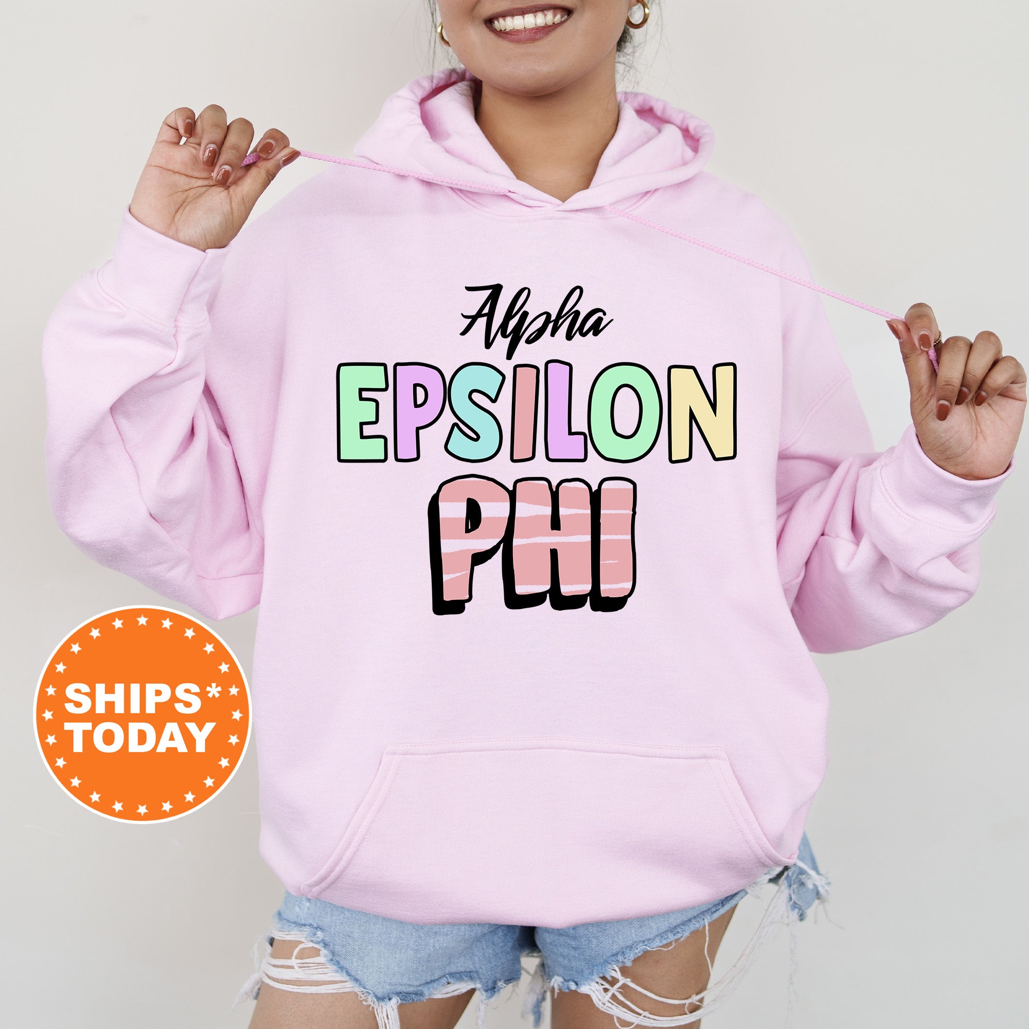 a woman wearing a pink hoodie with the words epiloon phi on it