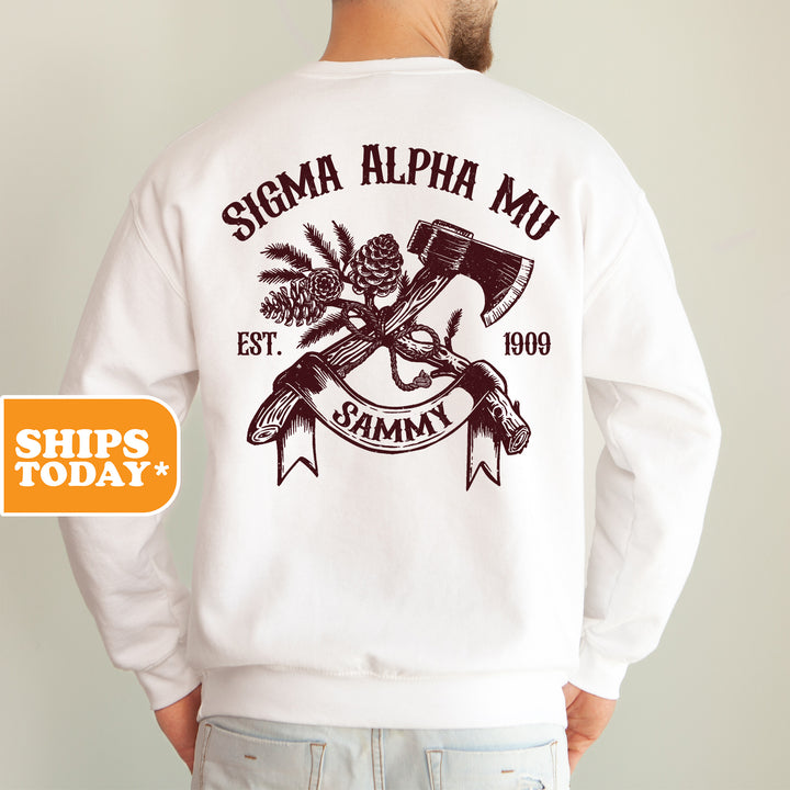 a man wearing a white sweatshirt with an image of a hammer and a pine cone