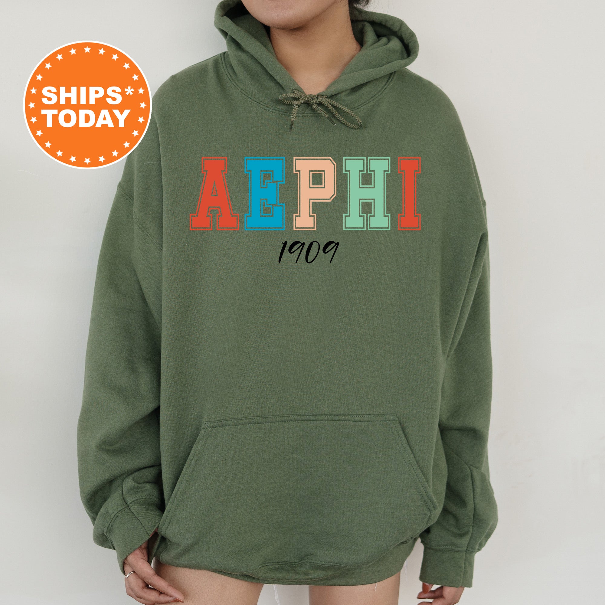 a woman wearing a green hoodie with the word aephi printed on it