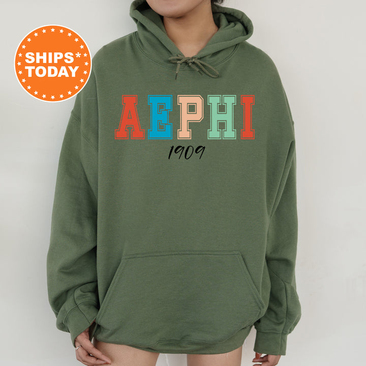 a woman wearing a green hoodie with the word aephi printed on it
