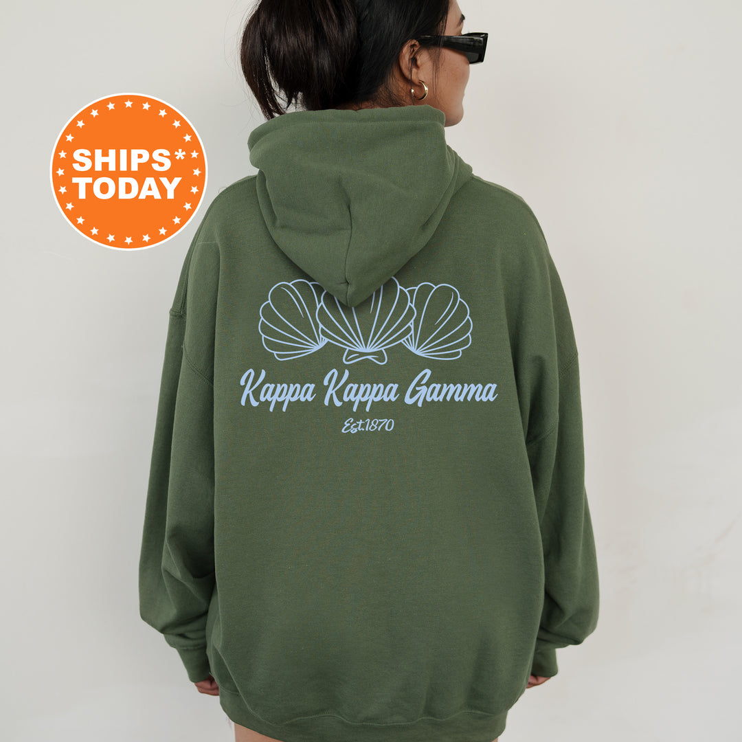 A person wearing a green hoodie with the text " Kappa Kappa Gamma" printed on the back.