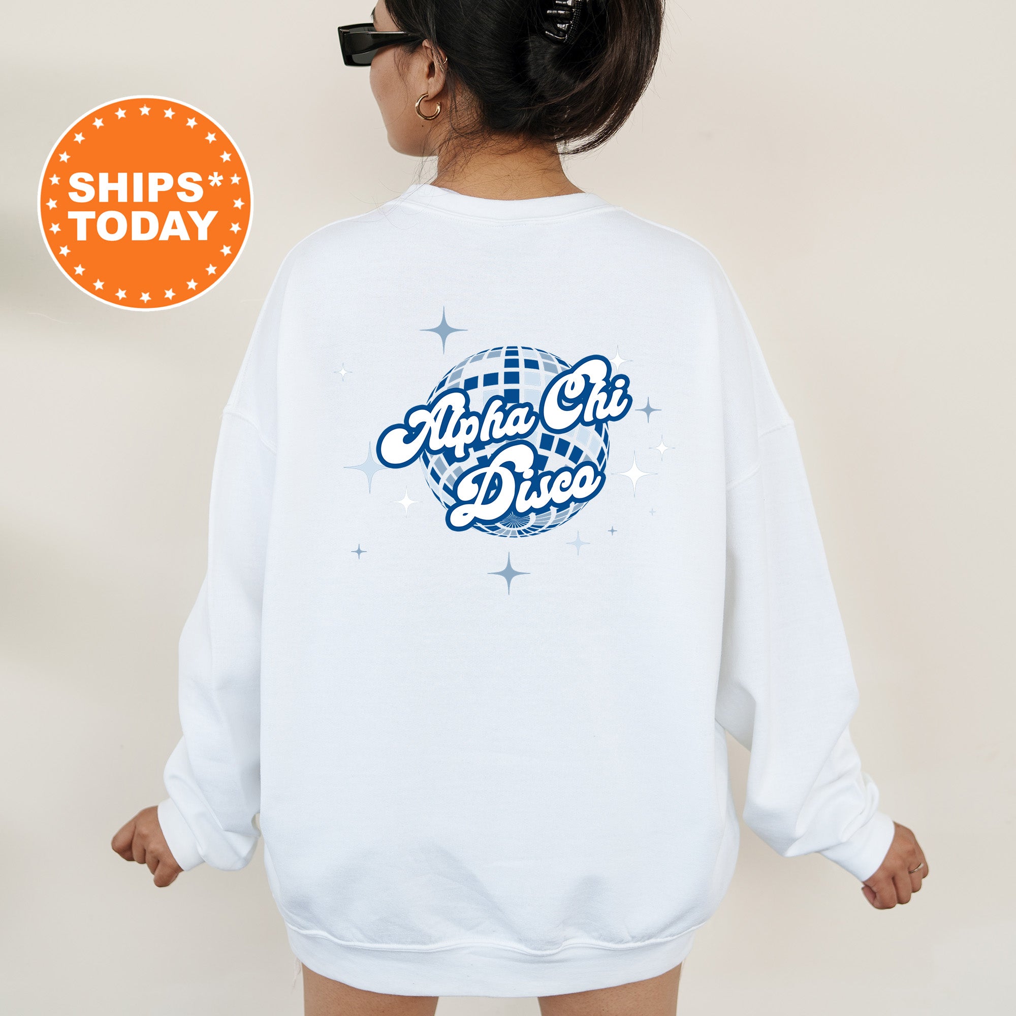 A person wearing a white sweatshirt with a graphic design on the back, featuring a blue and white disco ball and the text 