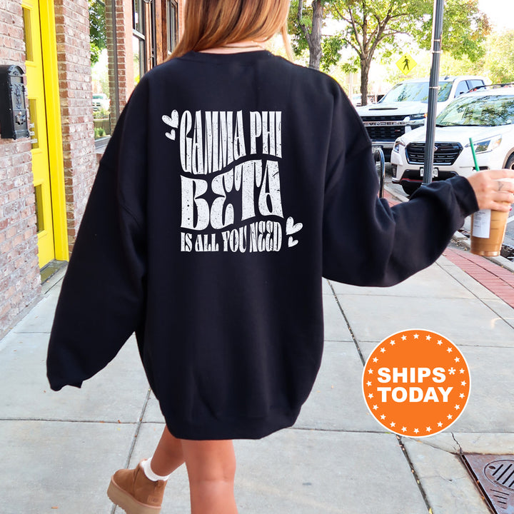 a woman walking down a sidewalk wearing a black sweatshirt