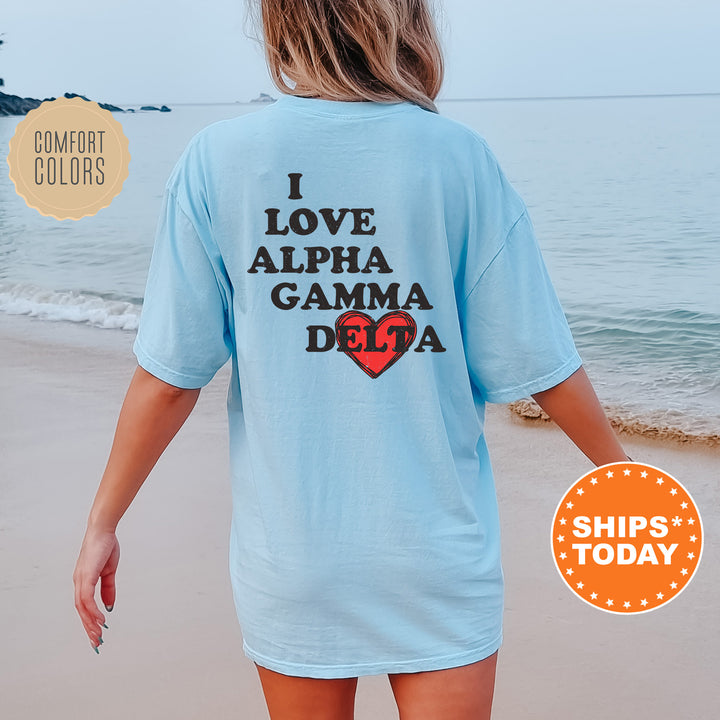 a woman walking on the beach wearing a light blue shirt