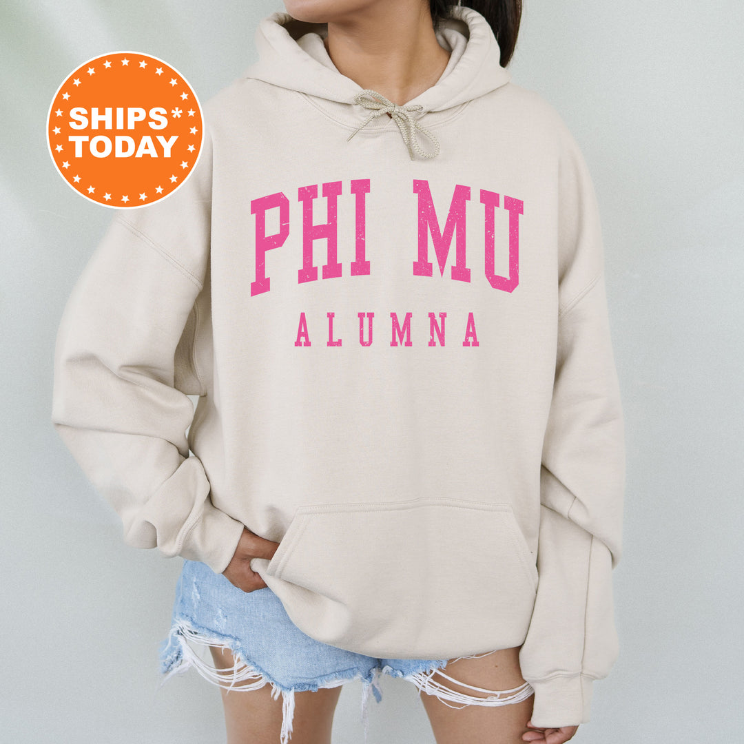 a woman wearing a sweatshirt with the words phi mu on it