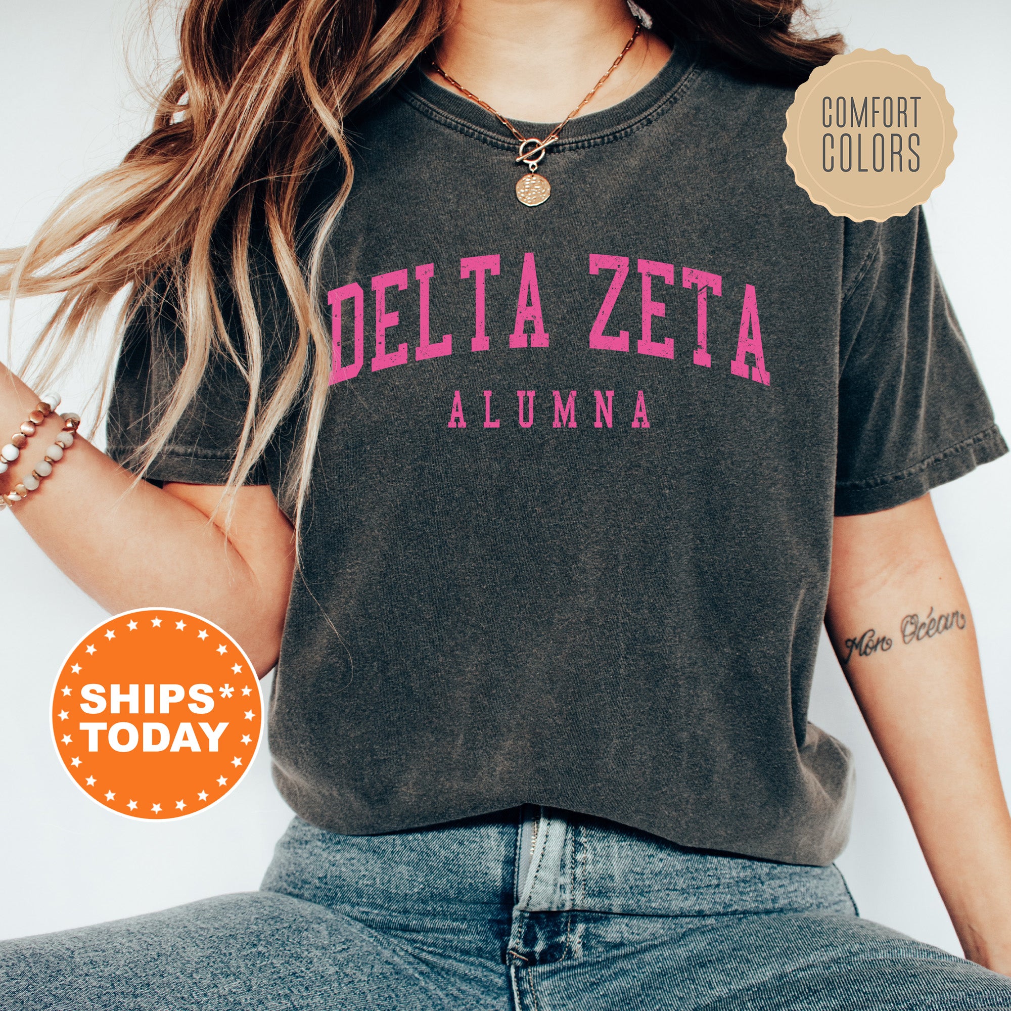 a woman wearing a black delta zeta shirt