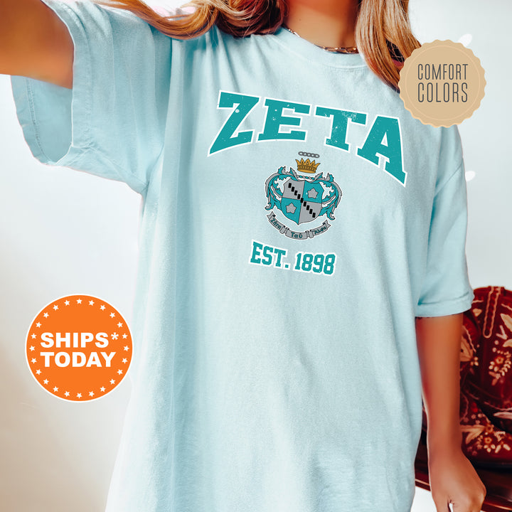 a woman wearing a blue zeta t - shirt
