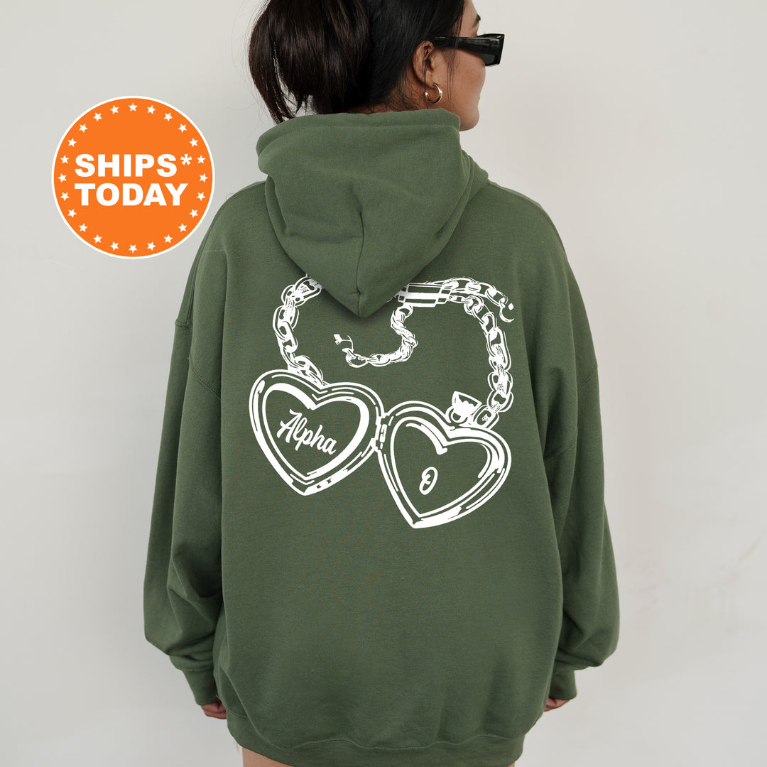 A person wearing a green hoodie with a graphic design on the back.
