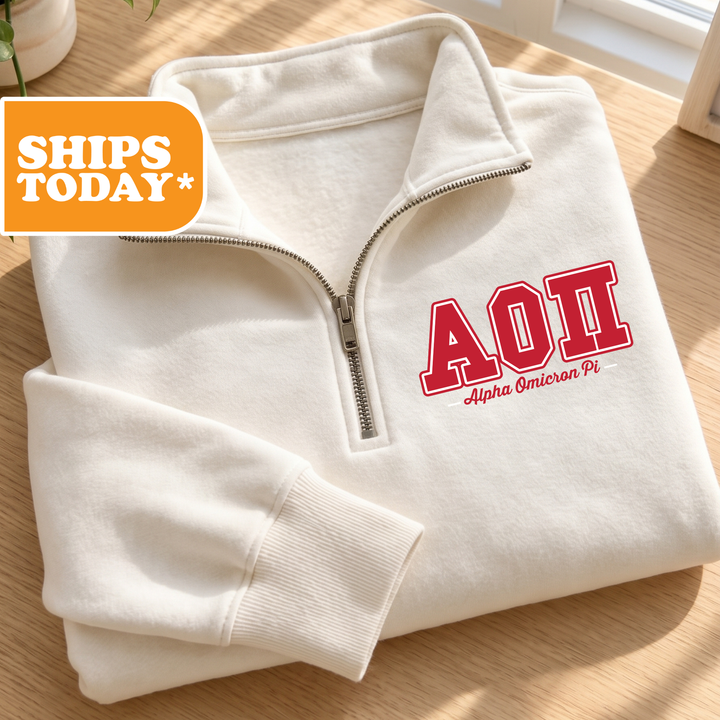 A white zip-up jacket with the letters "AΔΕΛΙ" printed on it, placed on a wooden surface.