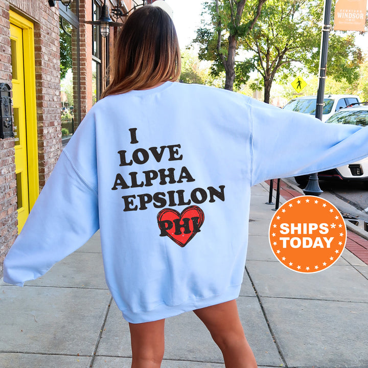 a woman walking down a sidewalk wearing a blue sweatshirt