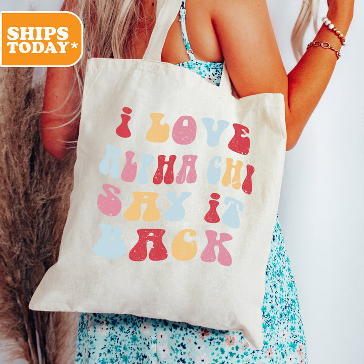 a woman holding a tote bag with a message on it