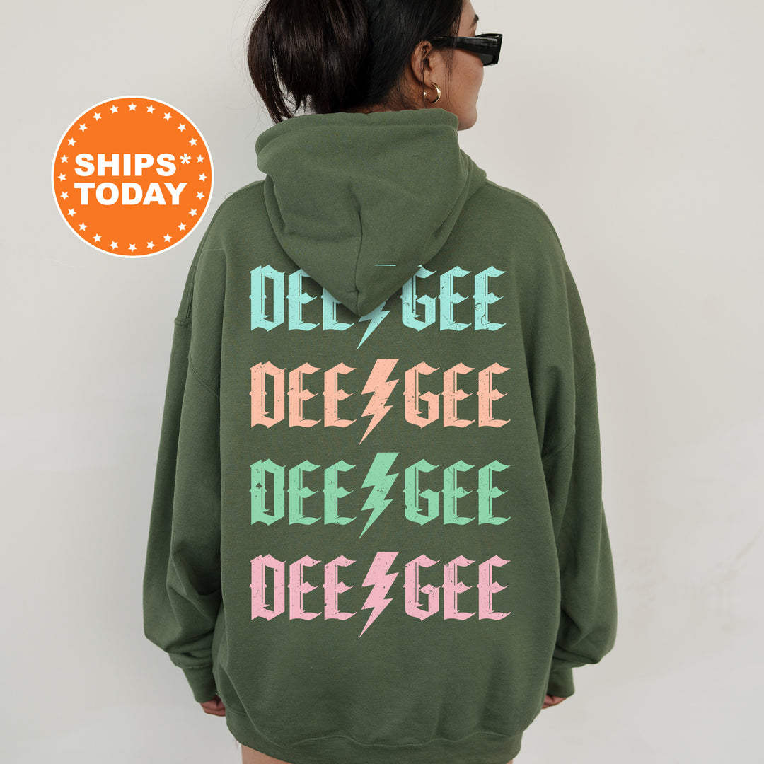 a woman wearing a green sweatshirt with pink and green letters on it