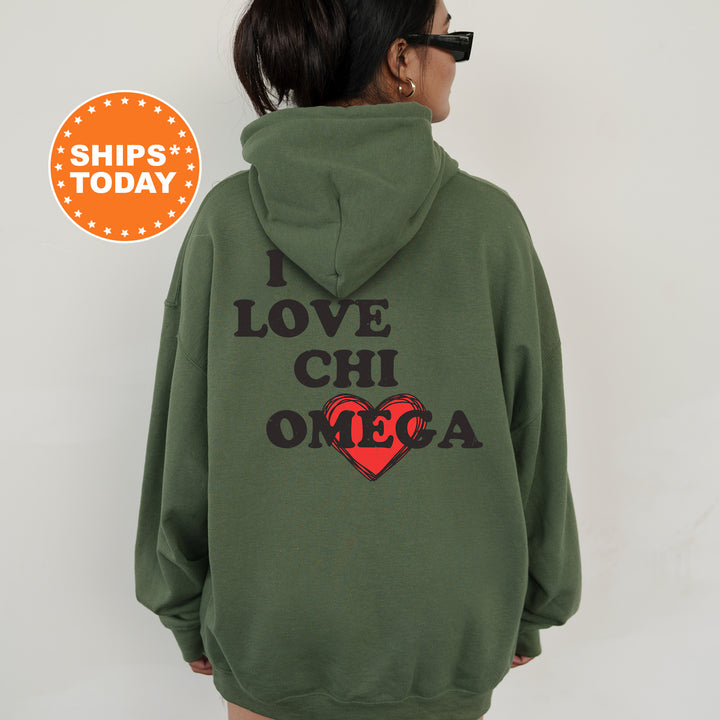 a woman wearing a green hoodie that says i love chi omega