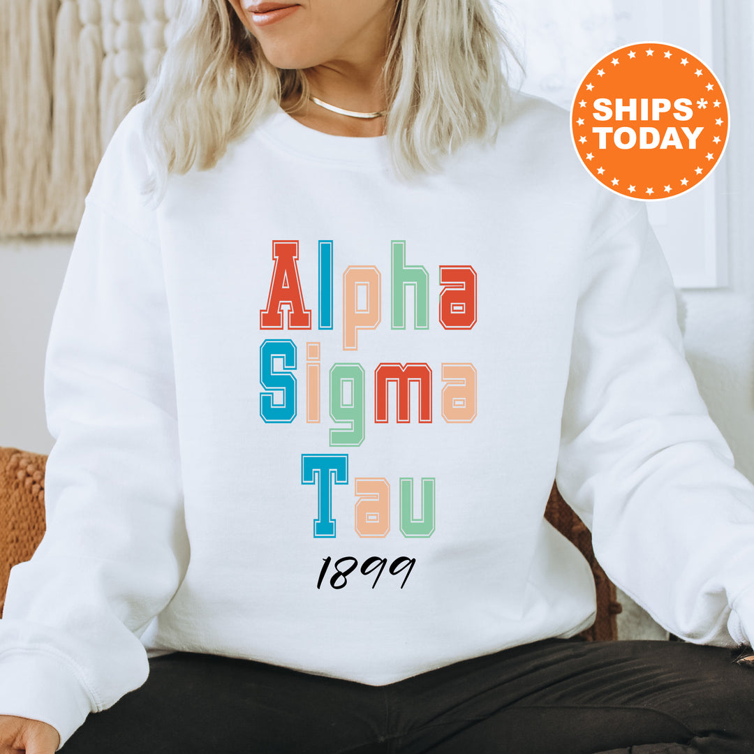 a woman sitting on a chair wearing a white sweatshirt