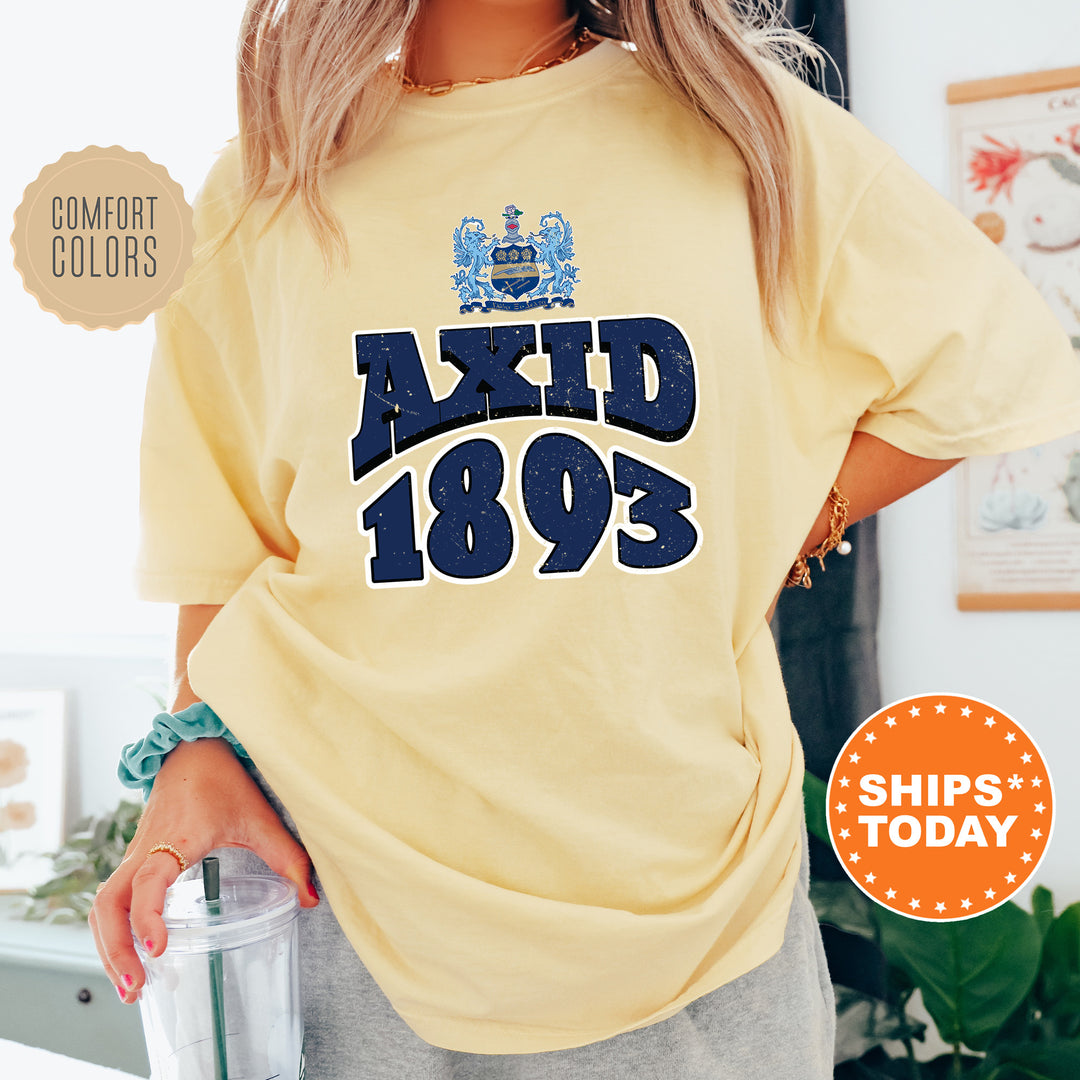 a woman wearing a yellow shirt with a blue and white logo